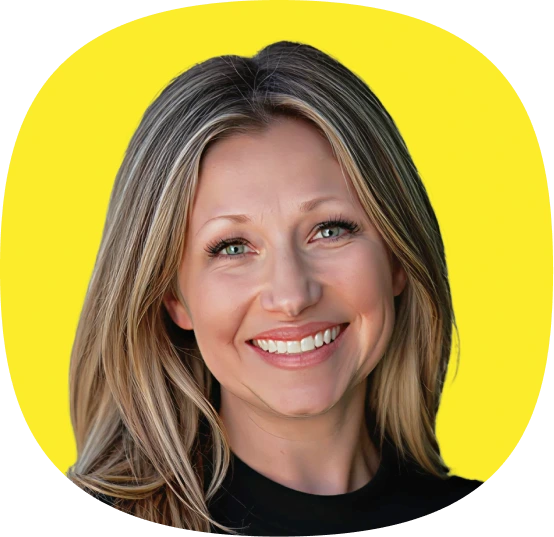 Smiling woman with long, straight blonde hair and blue eyes, wearing a black top, posed in front of a bright yellow background, highlighting the energy of Kustomer Winter Quarterly AI Innovations.